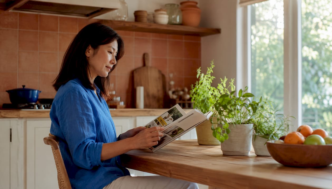 Woman reading with navy accent wall in living room