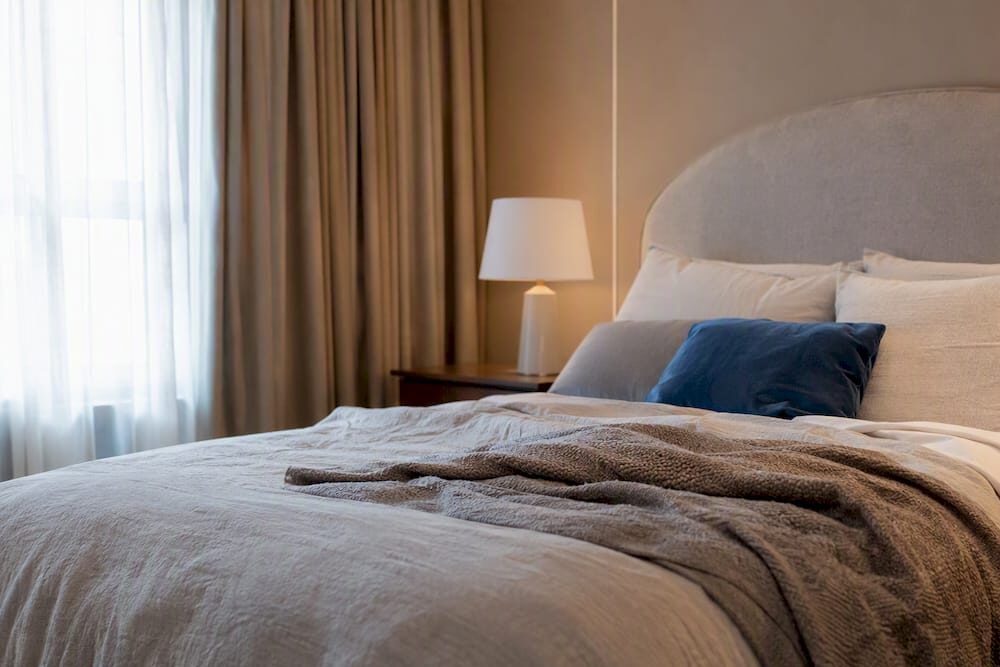 Serene hotel-style bedroom with neutral layers