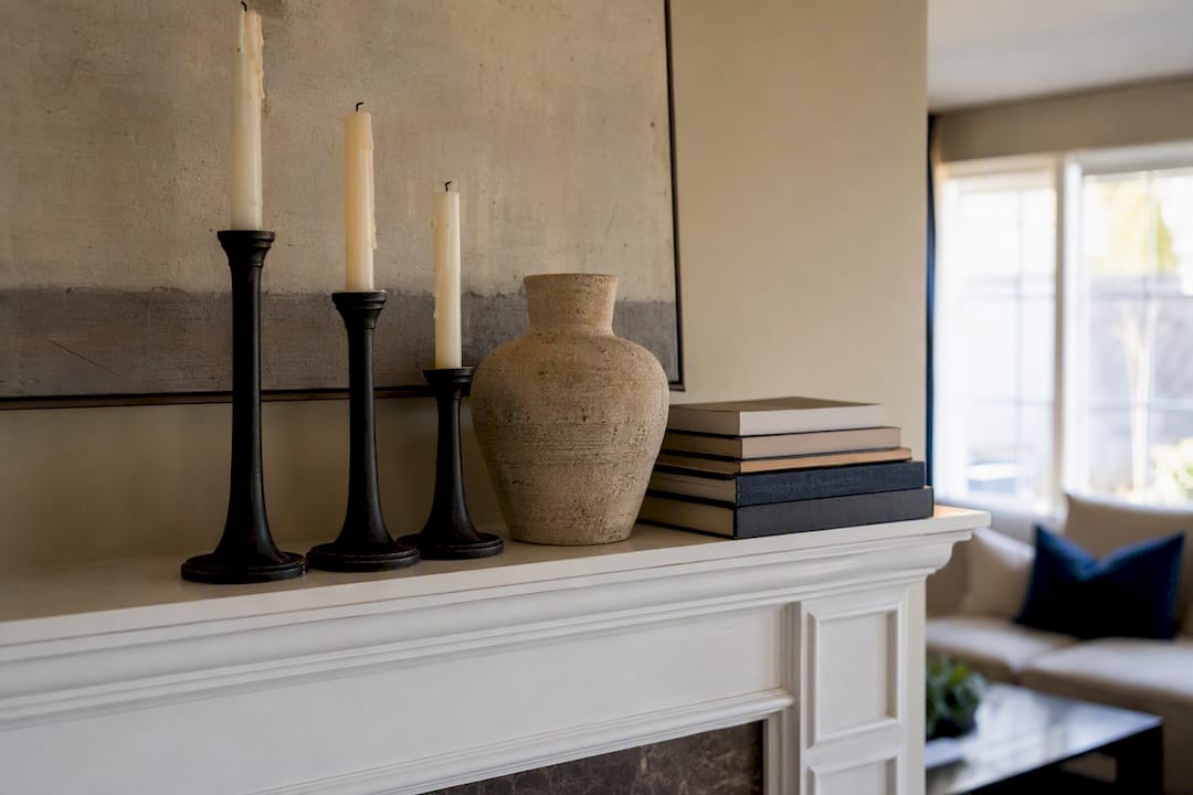 Mantel decor with varied height candlesticks and books