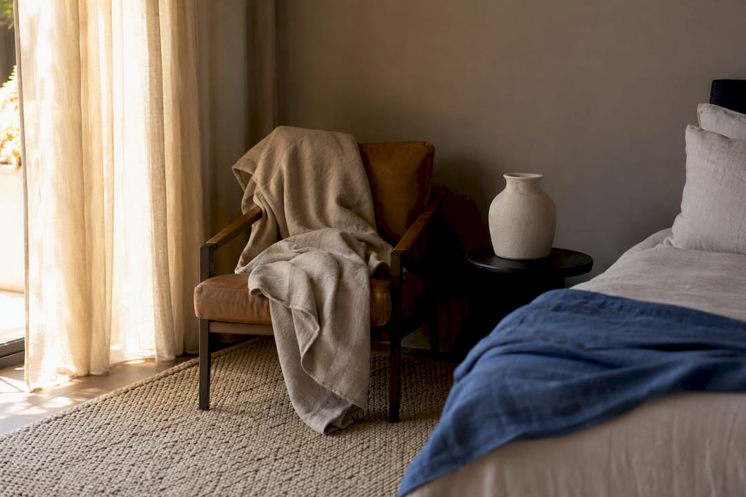 Layered linens and wool textures on chair