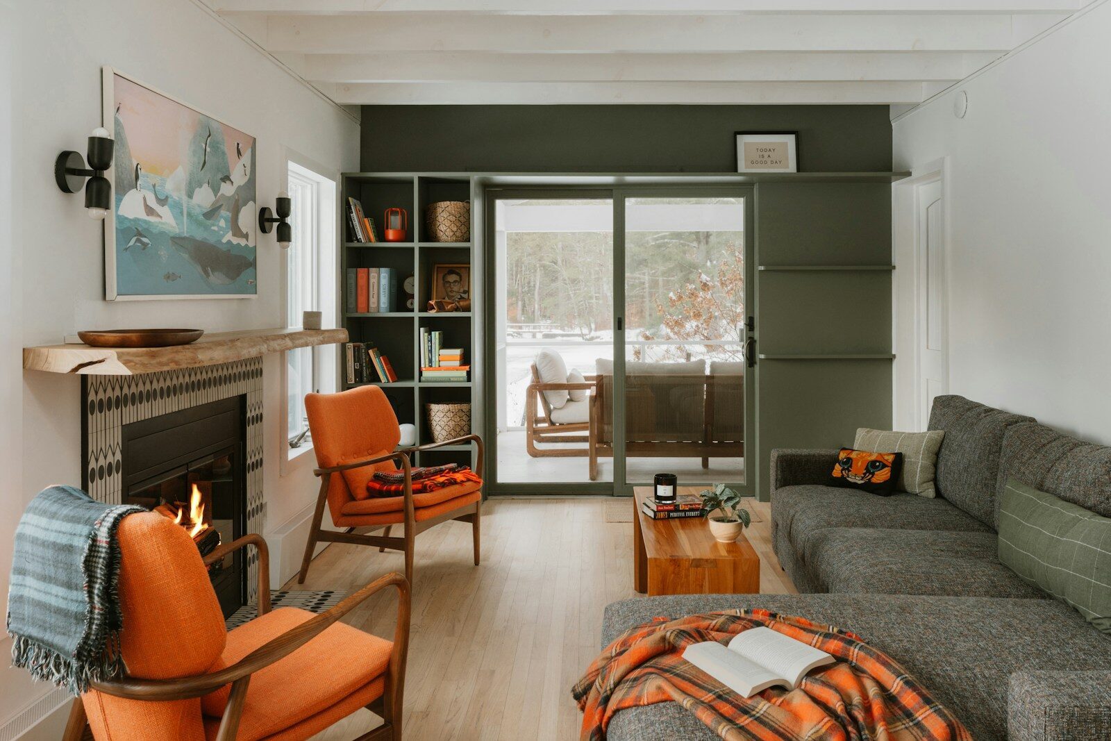 Cozy living room with fireplace and orange chairs