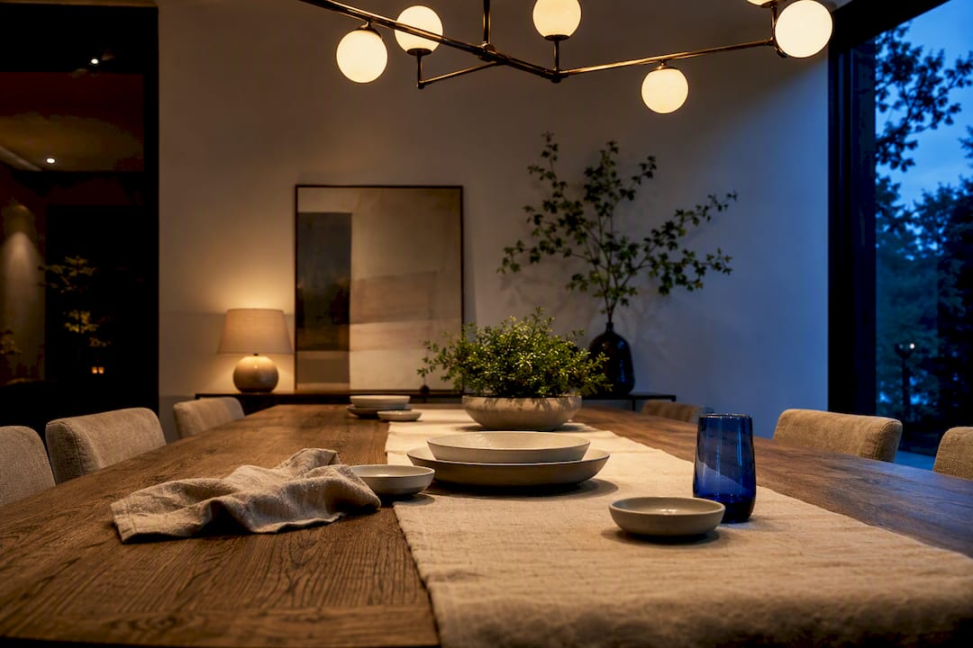 Chandelier aligned above contemporary dining table