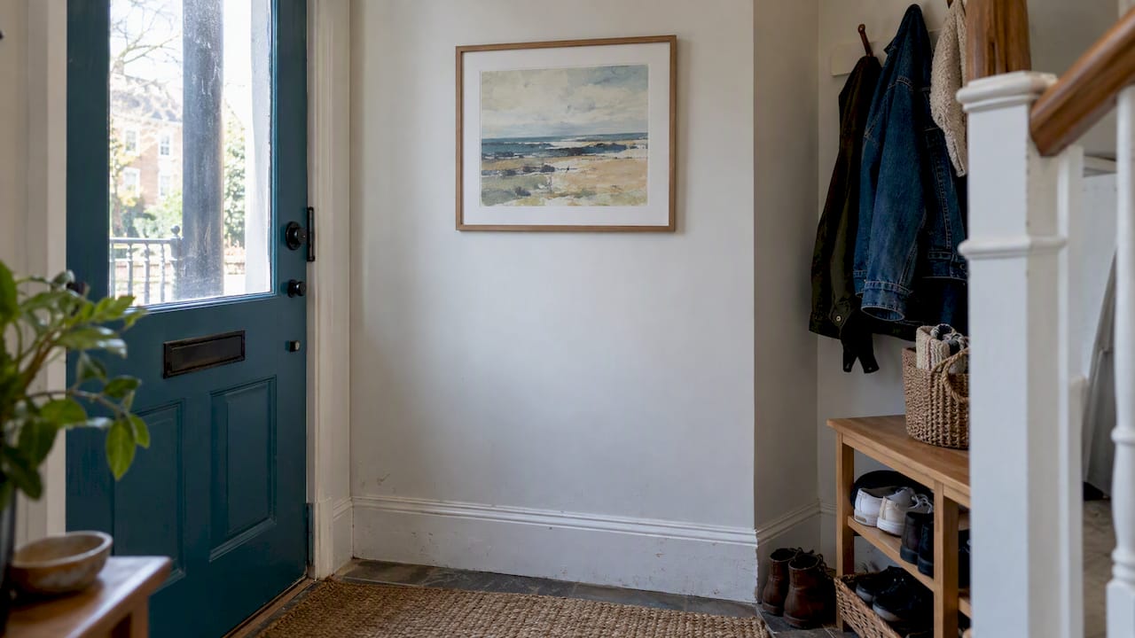 Framed print displayed in a townhouse entryway